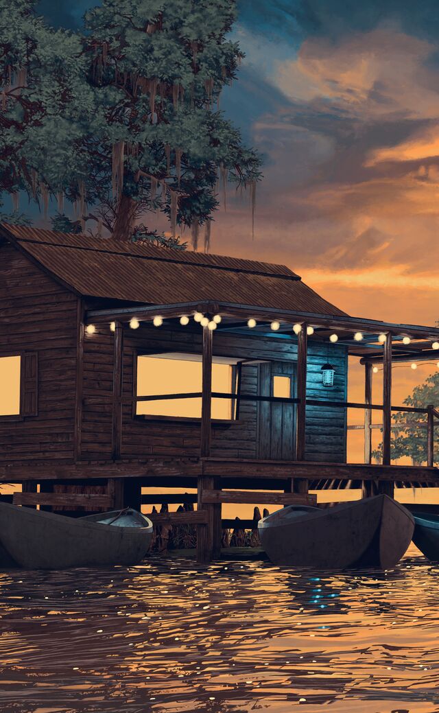 A view of a sunset on a Louisiana bayou; an egret is perching on a cypress knee next to a cypress tree looking toward a well-maintained fishing shack that has three pirogues docked at it; a bug zapper is visible hanging by the front door on a porch that is lit by lights strung around the tops of the wooden pillars holding it up